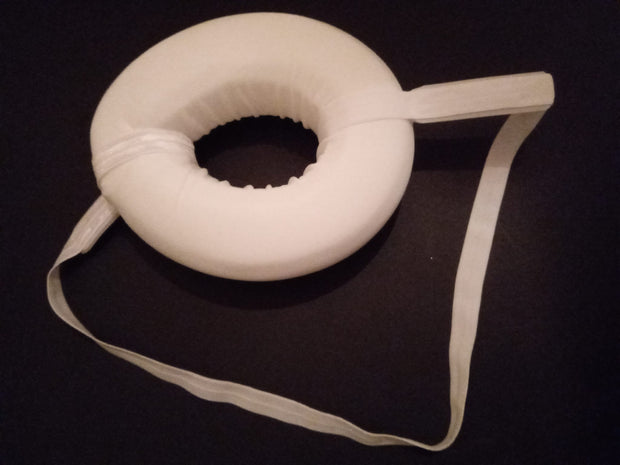 This is a 5 by 7 inch foam donut about 2 inches thick, comes with an elastic strap for the waist. The center hole is 3 by 2 inches and protects a stoma from the pressure of a seat belt.