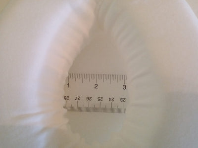 This is a 5 by 7 inch foam donut about 2 inches thick,  comes with an elastic strap for the waist. The center hole is 3 by 2 inches and protects a stoma from the pressure of a seat belt.